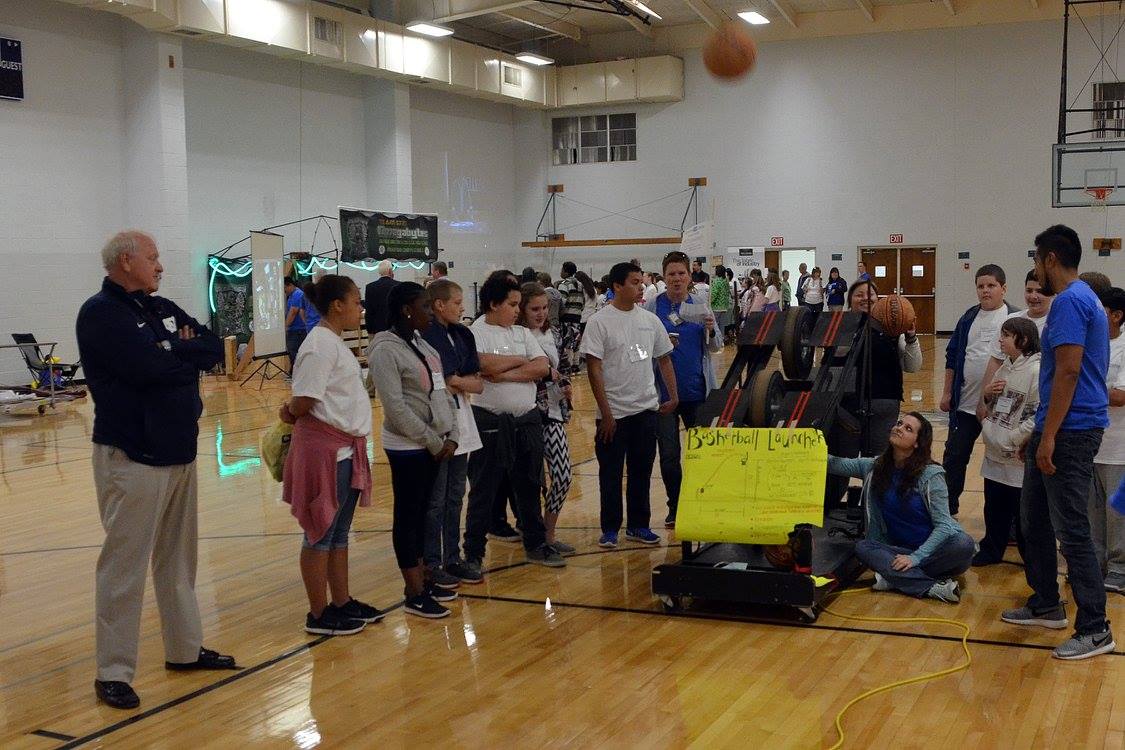 Basketball launcher in action shooting balls toward goal