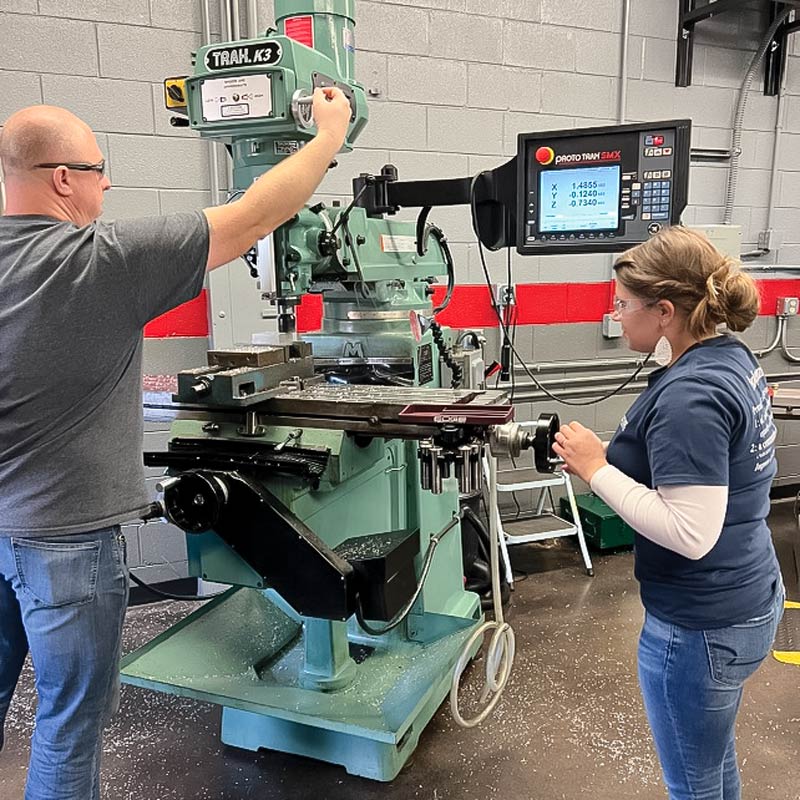 Student using large milling machine