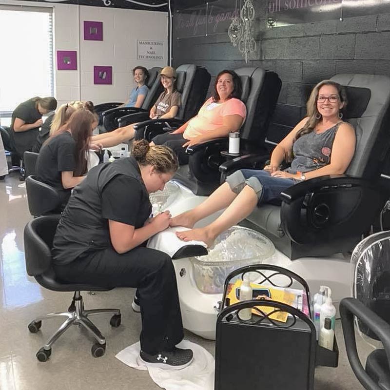 People getting pedicures in chairs in the lab