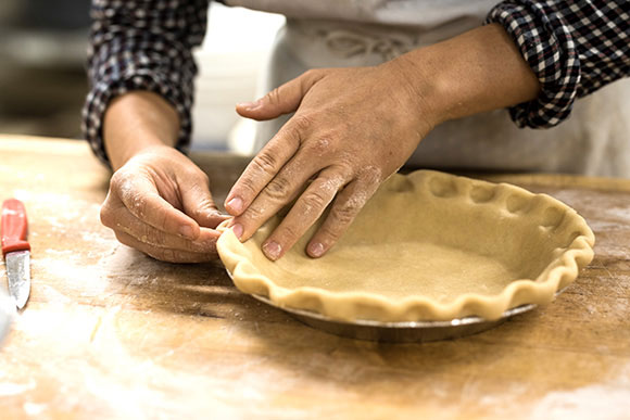 person making pie