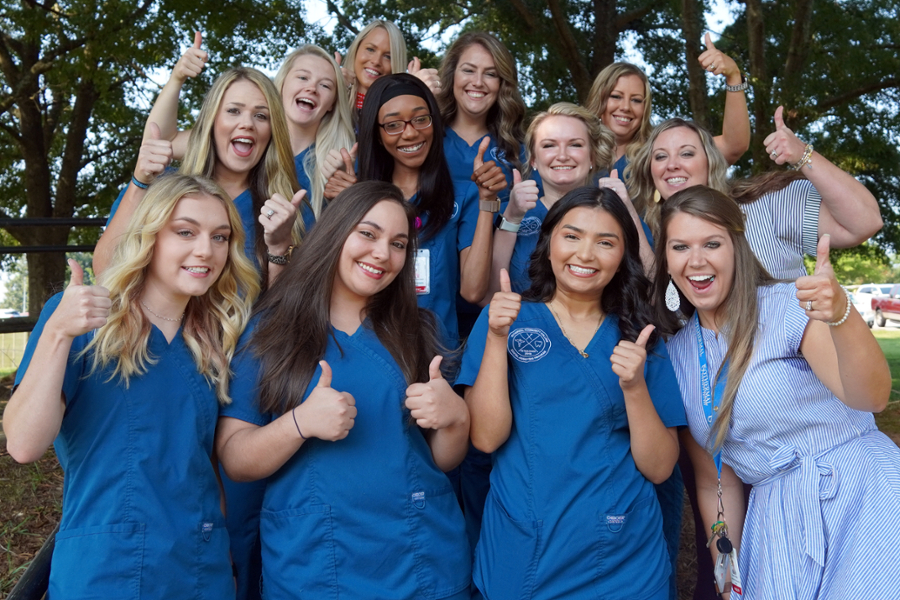 Dental students in scrubs cheering