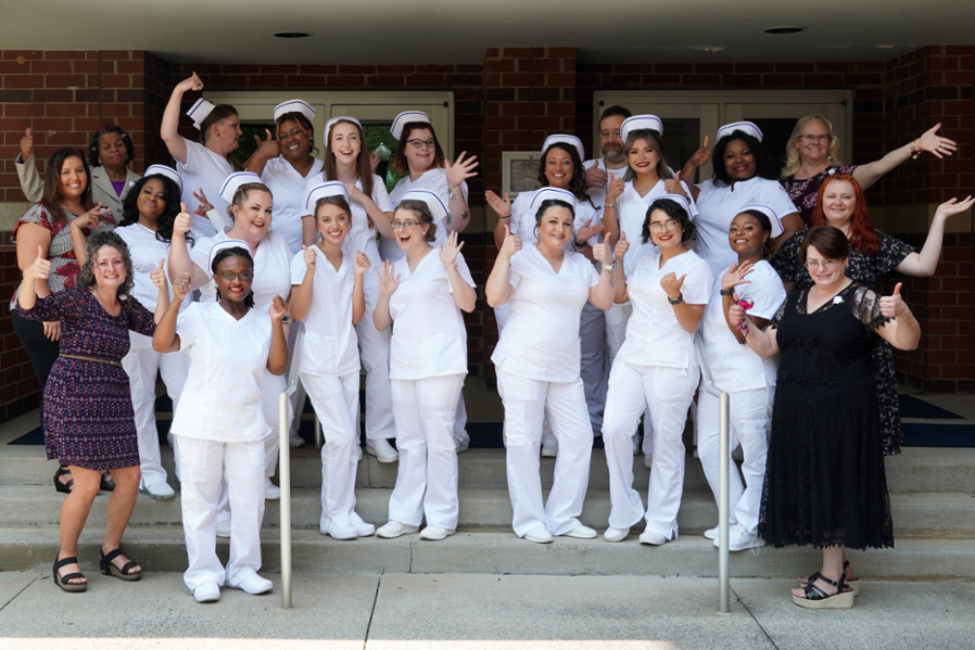 Nursing graduates with instructors in group.