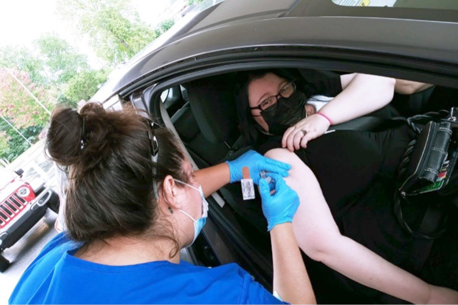 Andrea Hohrmann, a Practical Nursing student at Isothermal Community College, vaccinates Jessica Flynn, the administrative assistant for the program, at a recent clinic hosted by the Foothills Health District  at the Rutherford County Senior Center. 