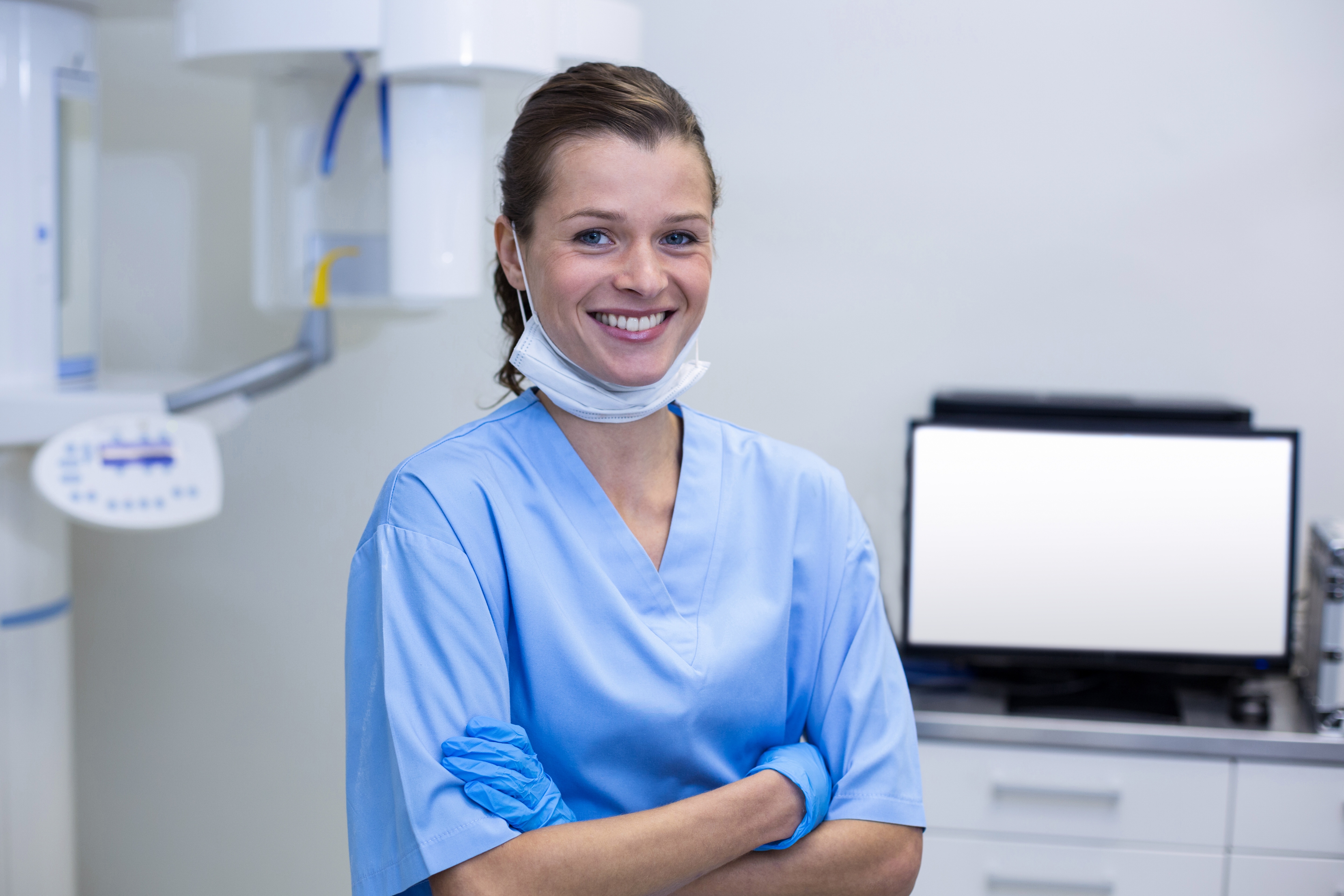 Dental assisting wearing a mask in an office setting.