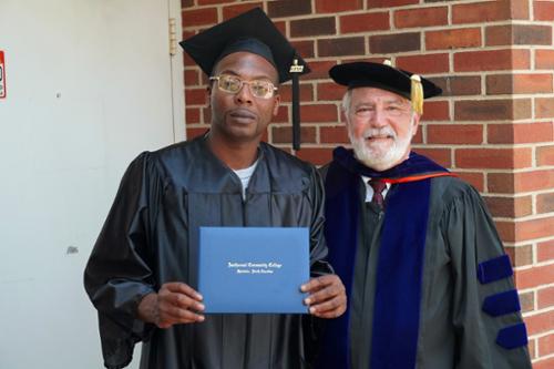 Jermain Porter standing with instructor Larry Gregg