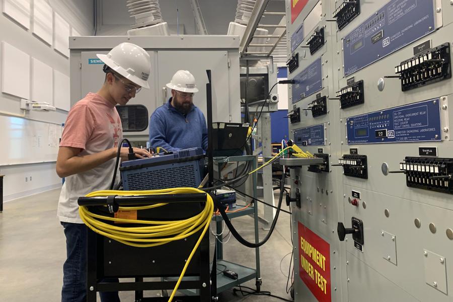 Zuriel Ramirez-Chavez and Justin Covil using instruments on a cart connected to a large instrument panel