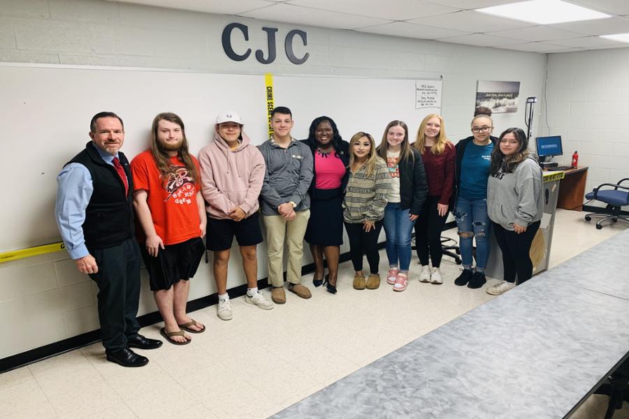 U.S. Attorney Dena King standing in a group photo with students from the class after her presentation