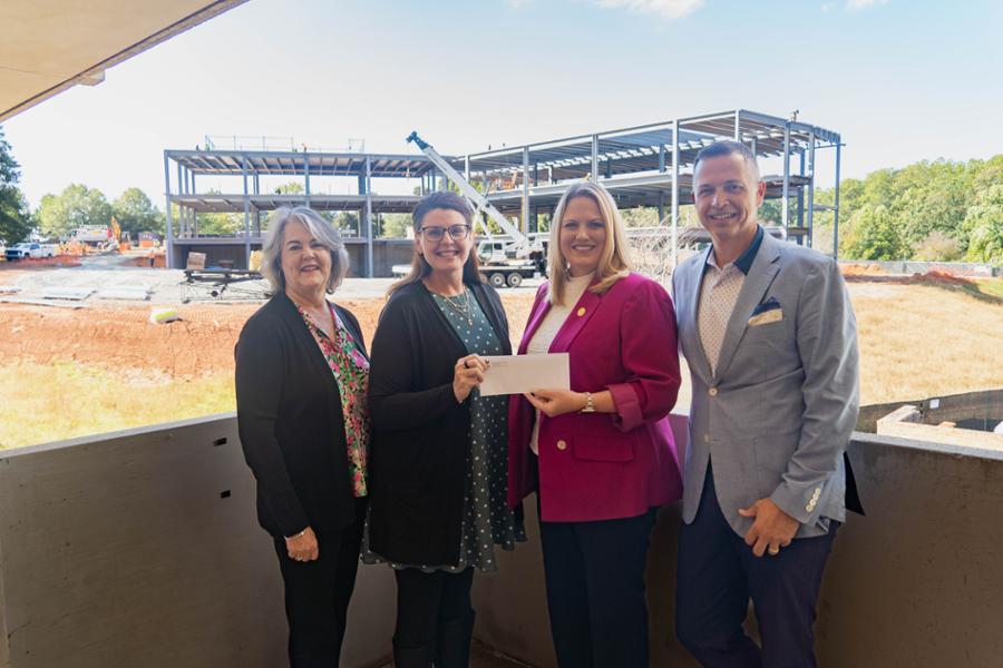 RHI representatives handing over a check to President Annunziata and VP Harrill.